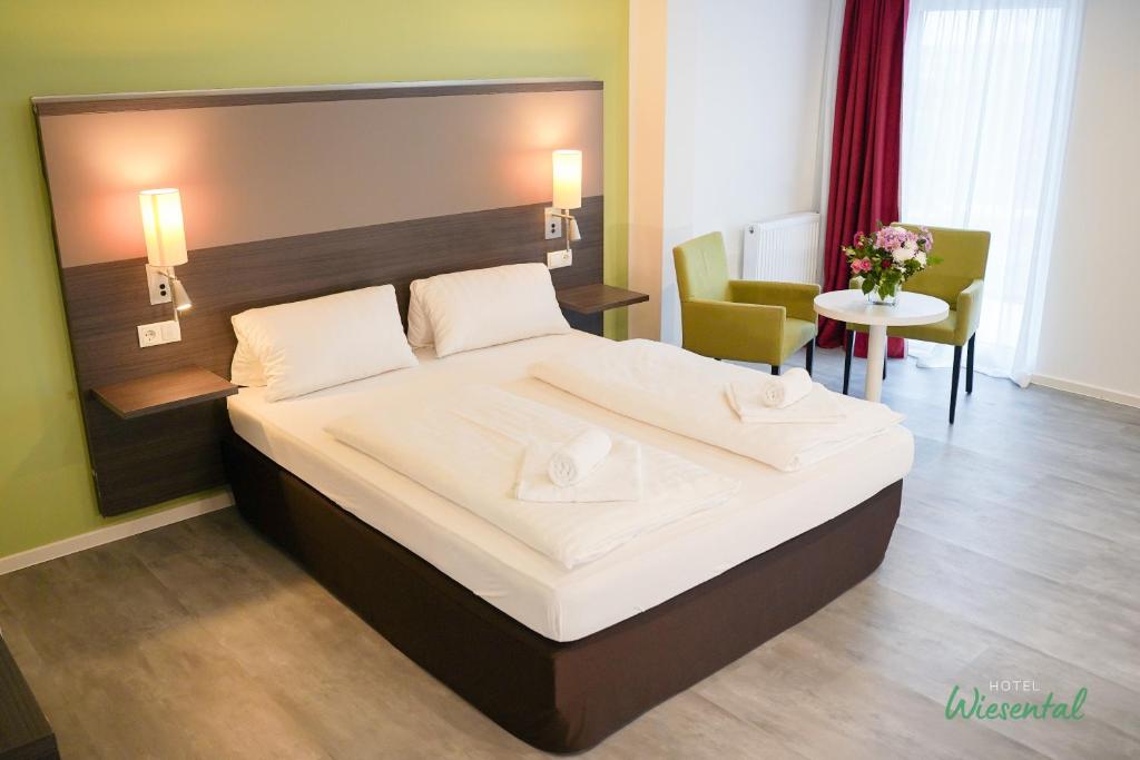 a bedroom with a large bed in a room at Hotel Wiesental Nähe Friedrichshafen in Meckenbeuren