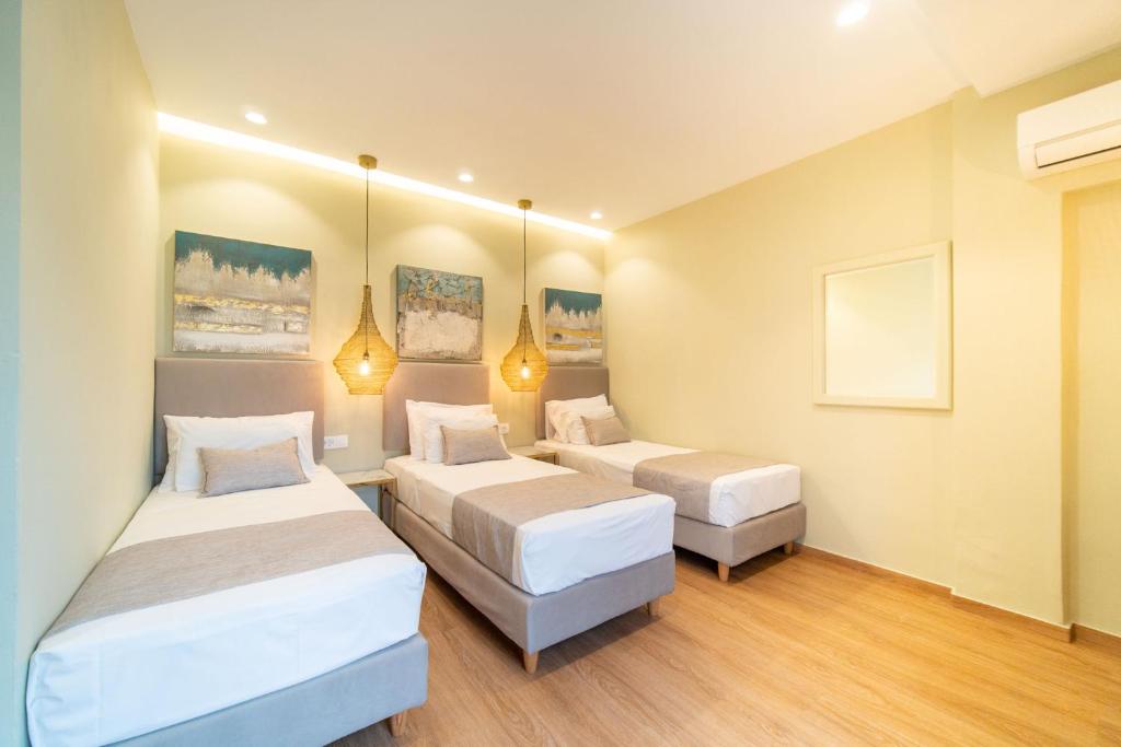 Postel nebo postele na pokoji v ubytování Antonia Hotel