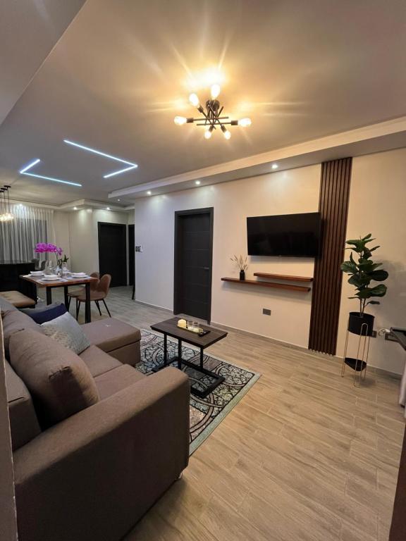 a living room with a couch and a flat screen tv at Apartamentos Orquidea Dorada apt 101 & 104 in Comayagua