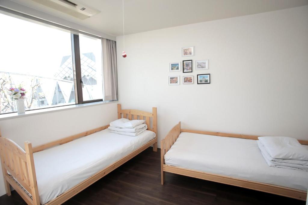 Postel nebo postele na pokoji v ubytování ゲストハウス昴