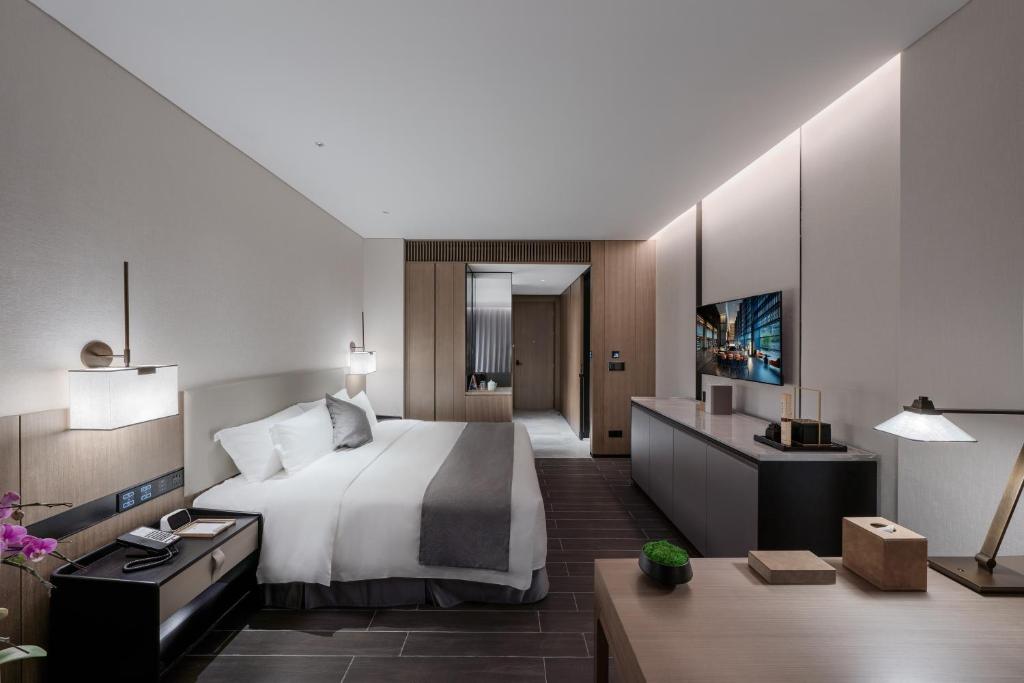 Postel nebo postele na pokoji v ubytování Genpla Hotel, Shenzhen Qianhai