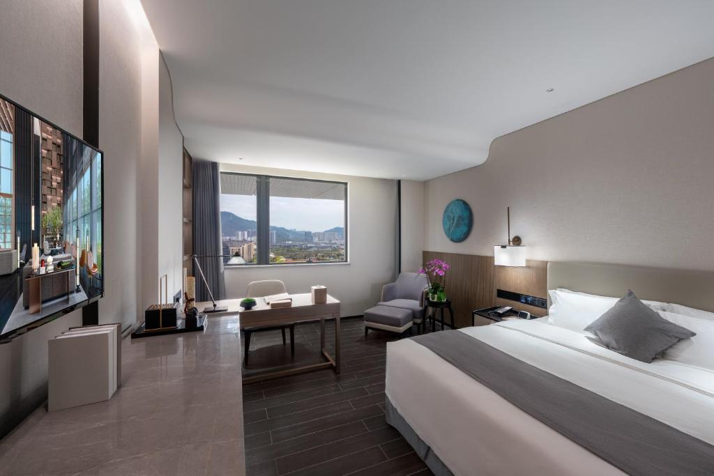 Postel nebo postele na pokoji v ubytování Genpla Hotel, Shenzhen Qianhai