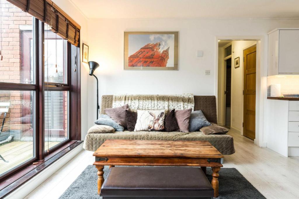 a living room with a couch and a coffee table at Luxury Islington Apartment with Balcony Islington in London