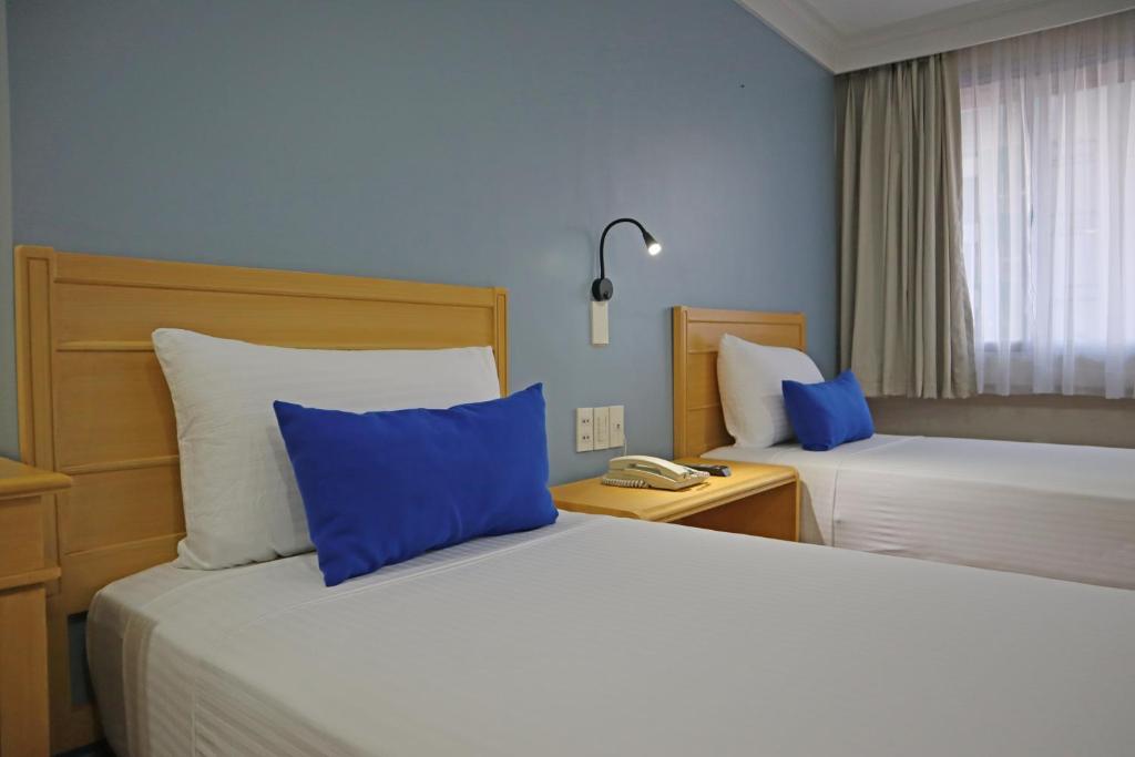 Postel nebo postele na pokoji v ubytování Fersal Hotel Malakas, Quezon City