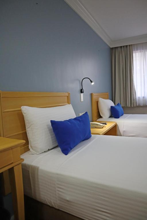 Postel nebo postele na pokoji v ubytování Fersal Hotel Malakas, Quezon City