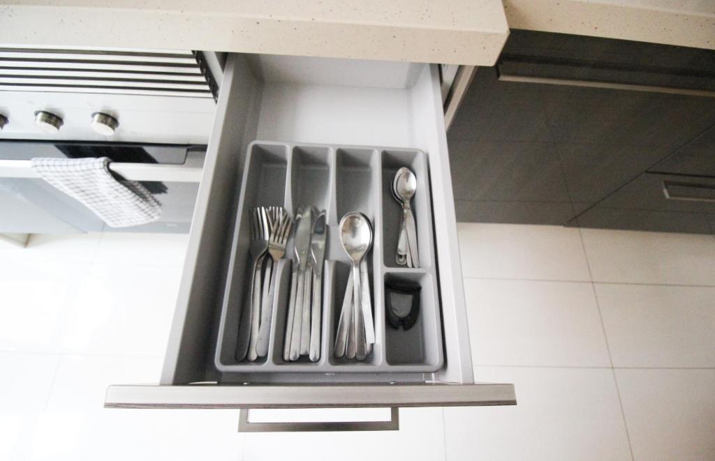 a utensil holder with utensils in a kitchen at Oriente DNA Studios V in Lisbon
