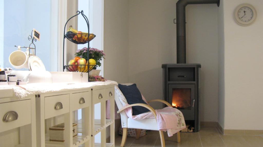 a kitchen with a table and a wood stove at Bed and Breakfast 57 in Asuel