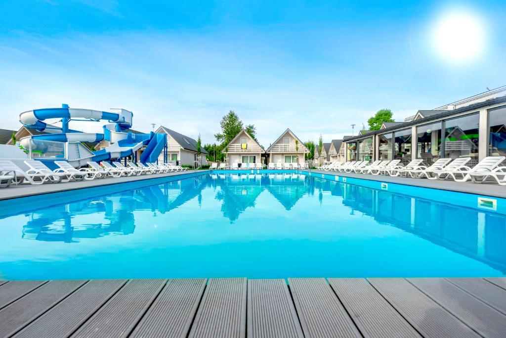 a large swimming pool with a water slide at Holiday Park & Resort Ustronie Morskie in Ustronie Morskie