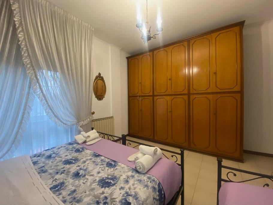 - une chambre avec un lit et une armoire en bois dans l'établissement Fronte Fiera Apartment, à Pero