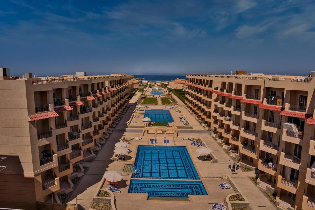an aerial view of an apartment complex with two swimming pools at Selena Bay Resort & Beach Club in Hurghada