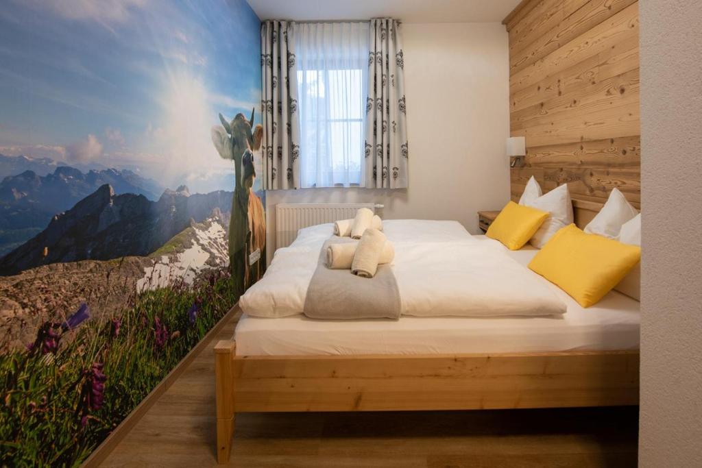 a bedroom with a bed with a teddy bear on it at FEWO Immenstadt in Immenstadt im Allgäu