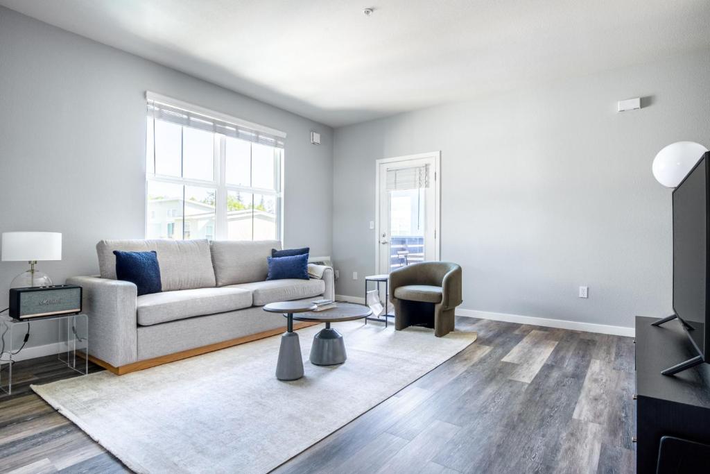 a living room with a couch and a table at Santa Clara 3BR w Gym Pool WD nr highways SFO-463 in Santa Clara