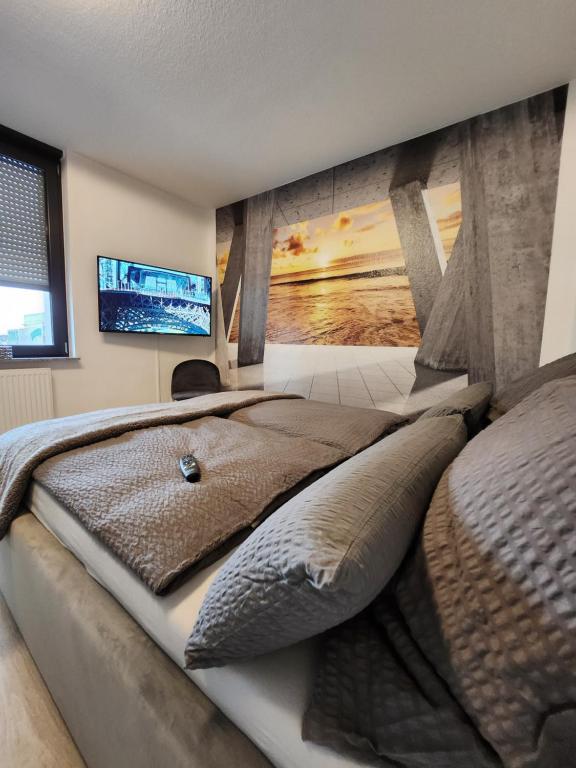ein Schlafzimmer mit einem großen Bett und einem TV an der Wand in der Unterkunft Stilvolles Appartement in Bielefeld