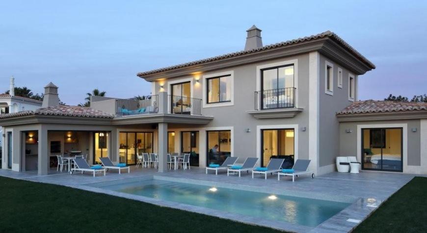a house with a swimming pool in front of it at Luxurious Algarve Villa Villa Manou 5 Bedrooms Private Heated pool 300m from the Beach Carvoeiro in Carvoeiro