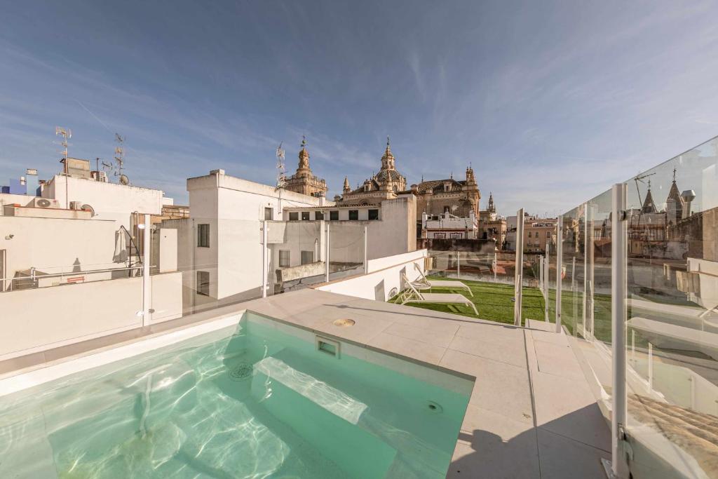a swimming pool on the roof of a building at Indulge en Sevilla Cuna in Seville