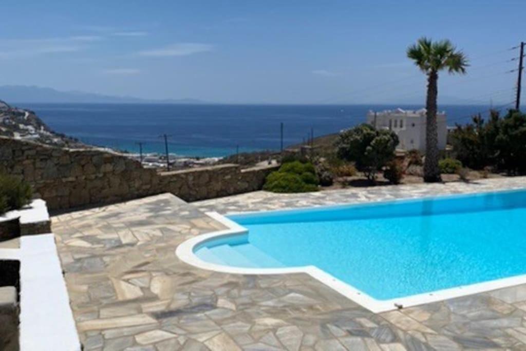 a swimming pool with a view of the ocean at Villa Anna in Elia Beach
