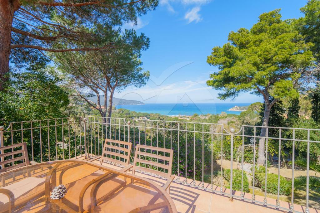 a balcony with two chairs and a view of the ocean at Villa il Cappero View & Beach - Goelba in Procchio