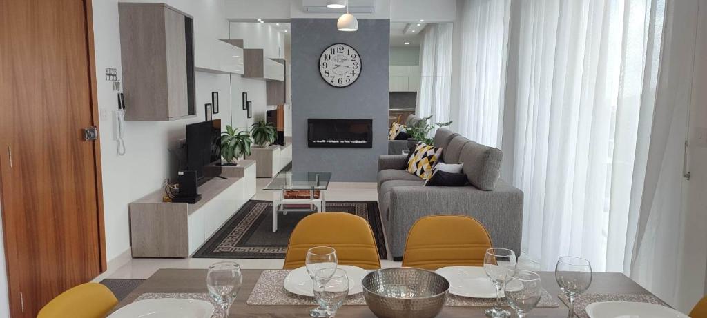 a dining room with a table and chairs and a living room at Bright Stylish Apartment in Victoria