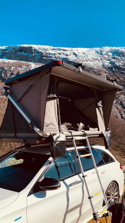 a car with its roof open with its trunk at Rent Rooftop tent for car with roofrack in Stavanger