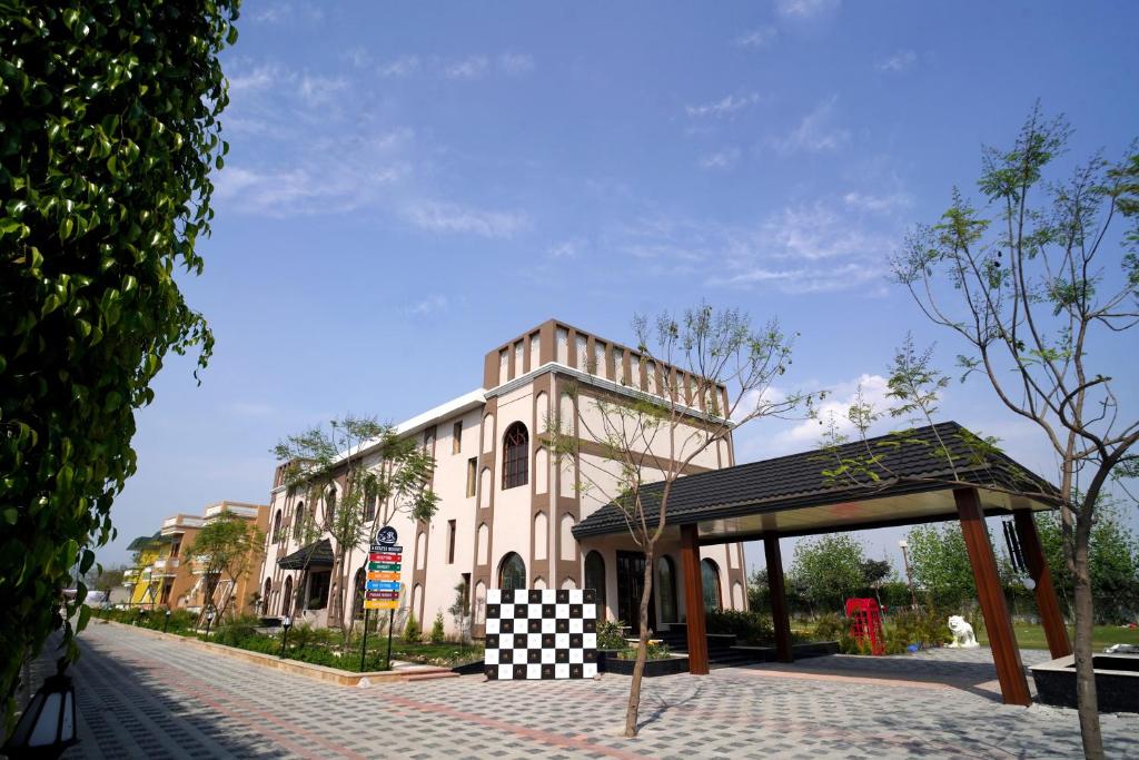 a large building with a checkered canopy next to a street at 5 States Resort in Amritsar