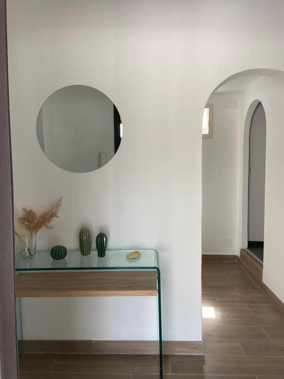 a room with a glass table and a mirror at Marea in Palermo