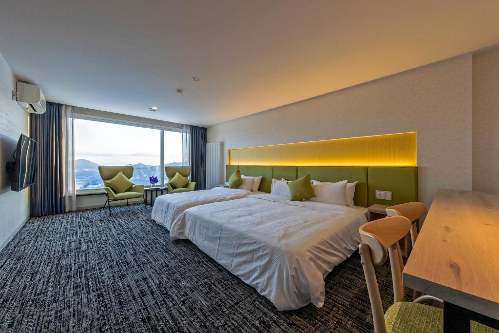 Postel nebo postele na pokoji v ubytování HOTEL COCOA RESORT