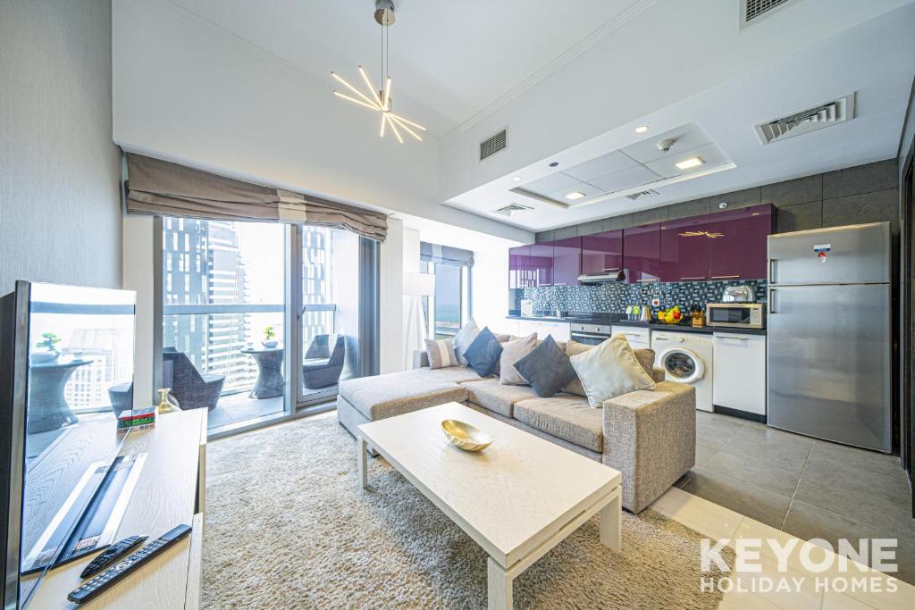 a living room with a couch and a table at KeyOne - 1BR in Cayan Tower in Dubai