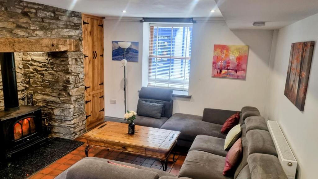 a living room with a couch and a fireplace at Brackendale in Bala