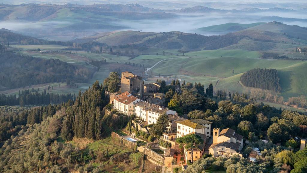 un castillo en la cima de una colina en las montañas en Castelfalfi, en Castelfalfi