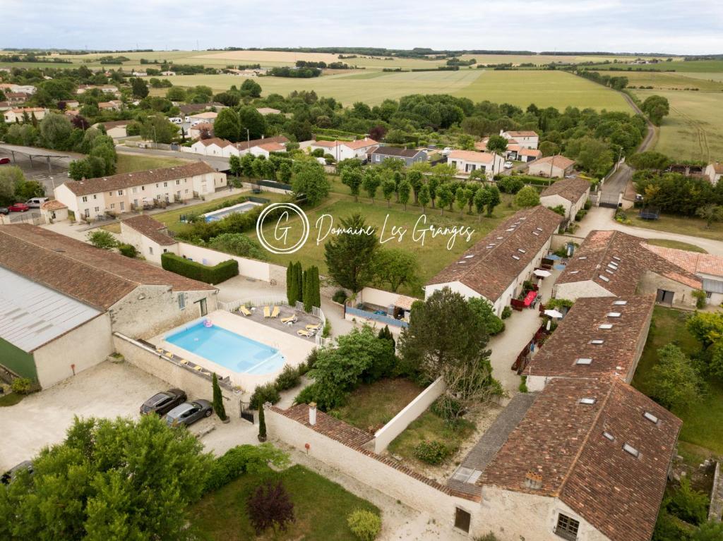 una vista aérea de una casa con piscina en Domaine Les Granges, en Saint-Jean-dʼAngély