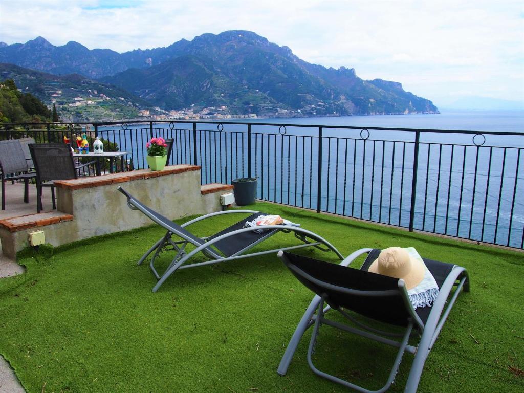a balcony with chairs and a view of the water at Casa Skyline a Ravello in Atrani