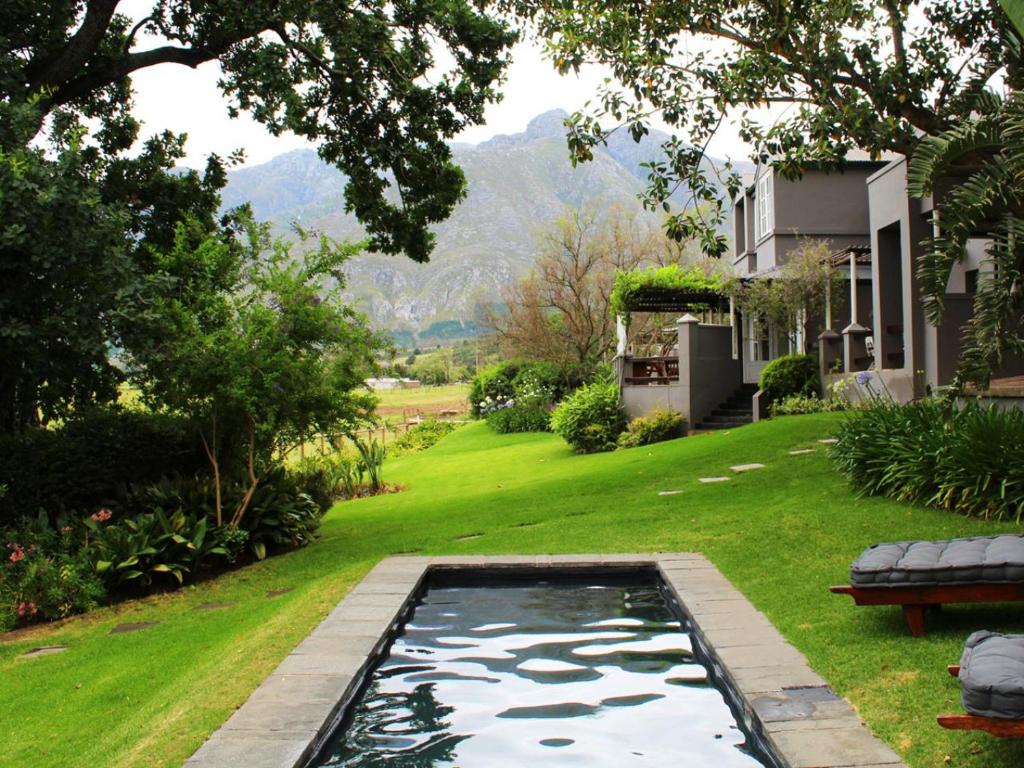 a pool in the yard of a house at Arumvale Country Retreat in Swellendam