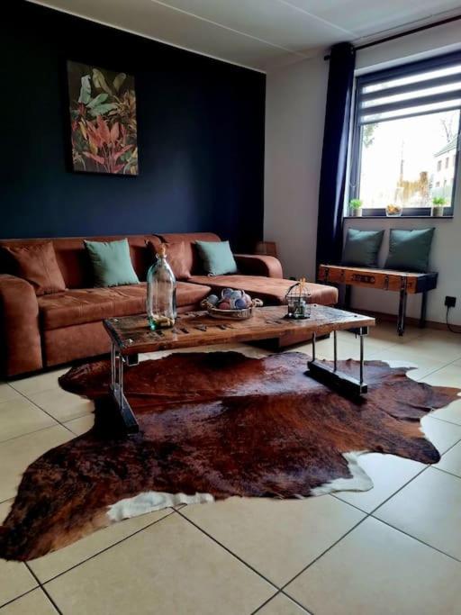 a living room with a couch and a coffee table at La parenthèse in Marche-en-Famenne