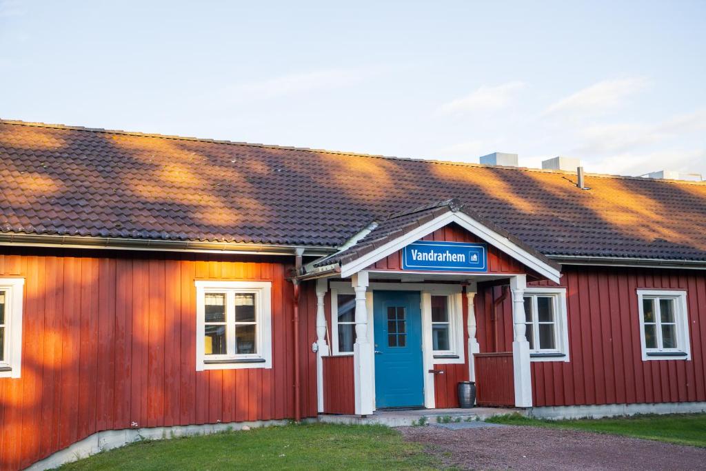 un edificio rojo con una puerta azul en Orsa Grönklitt, en Orsa
