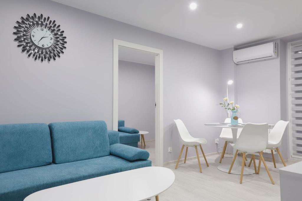 a living room with a blue couch and a table at Apartament z Balkonem in Jastrzębie Zdrój