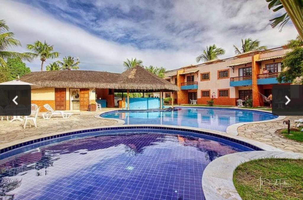 a view of the pool at the resort at Charmoso Chalé Triplex - Centro da Pipa in Pipa