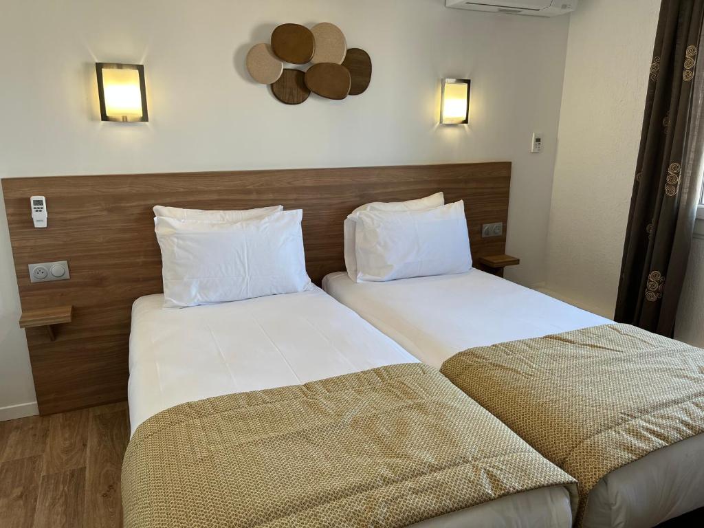 Postel nebo postele na pokoji v ubytování Hôtel Le Mirage