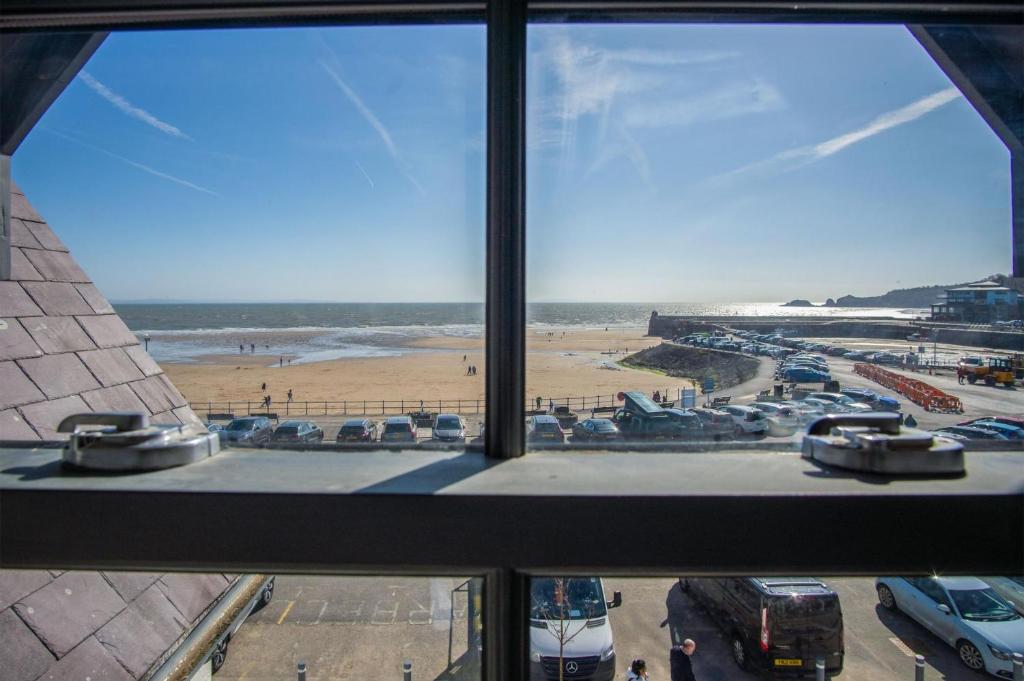 a view of the beach from a window of a building at Ocean Cabins No 13 At The Square - Saundersfoot in Saundersfoot