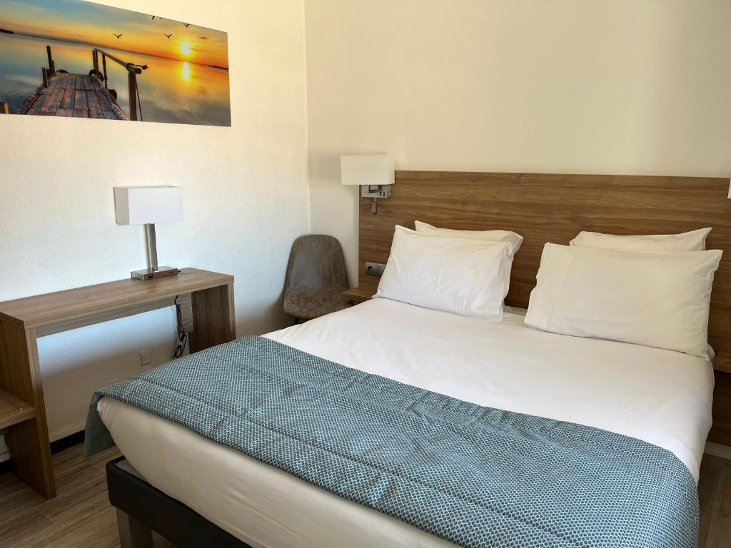 Postel nebo postele na pokoji v ubytování Hôtel Le Mirage