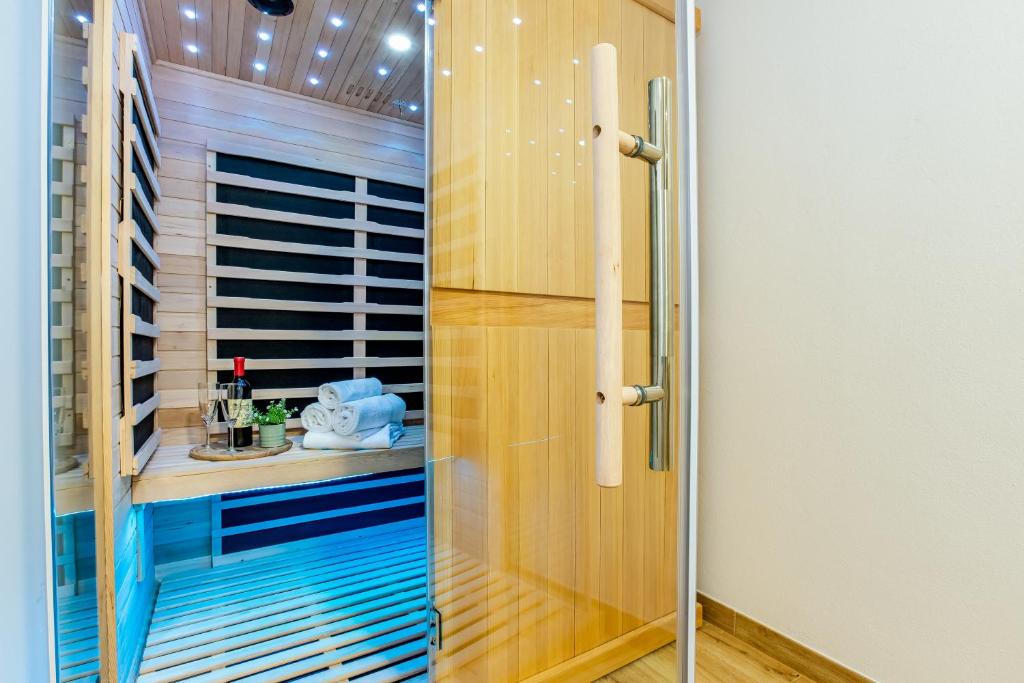 a shower with a glass door in a bathroom at Apartmány Karlovy Dvory in Horní Planá