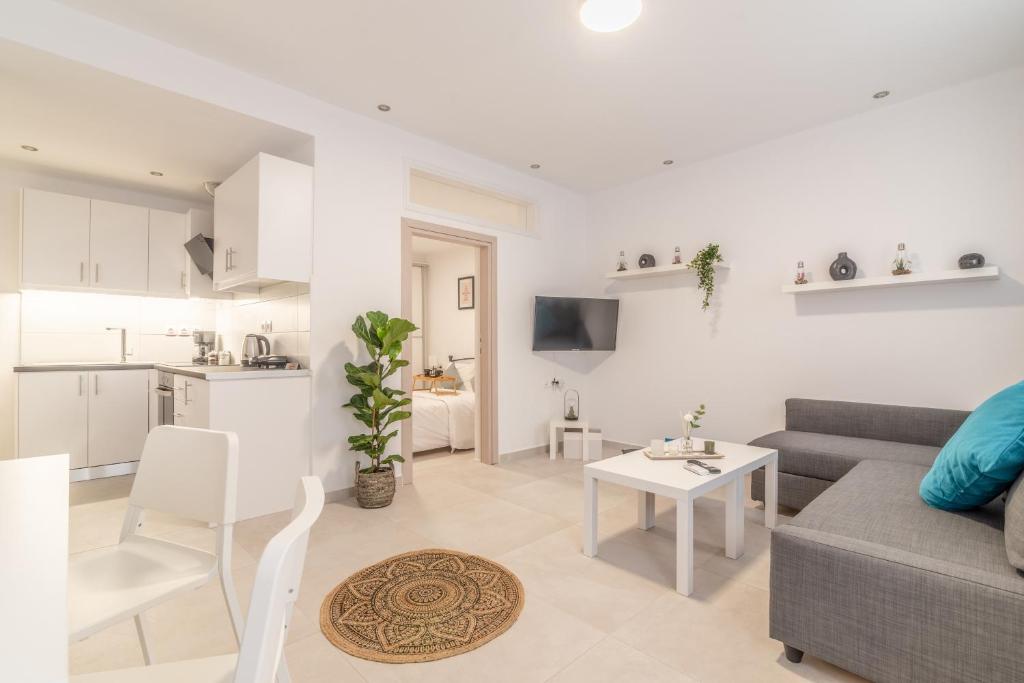 a living room with a couch and a table at Stylish & relax flat for friends & couples in Heraklio Town