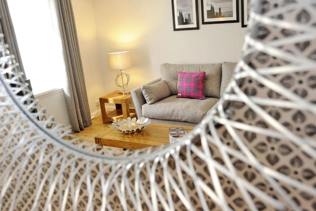 a living room with a couch and a chair at Claremont Gardens in Aberdeen