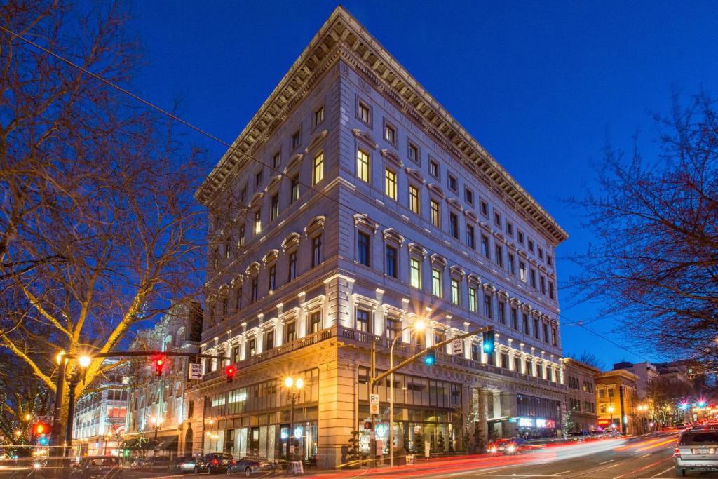 a large building on a city street at night at Sentinel Hotel in Portland