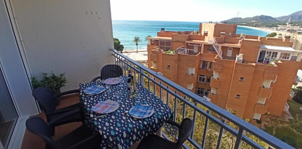 a table on a balcony with a view of the ocean at Arena in Hospitalet de l'Infant