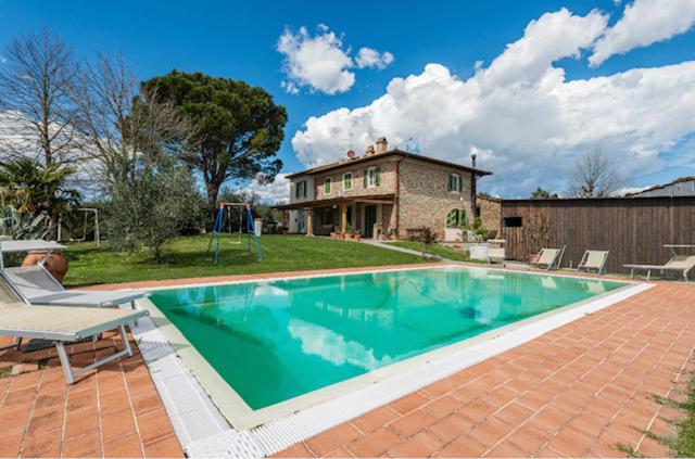 una gran piscina frente a una casa en Alloggio incantevole con piscina, en Vinci