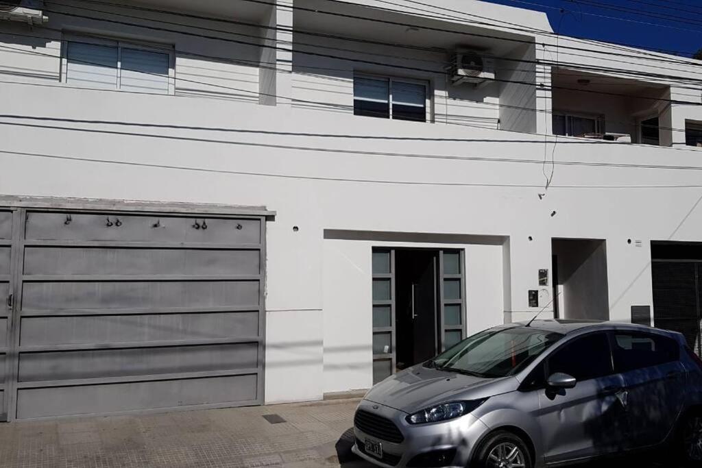 a silver car parked in front of a garage at San Luis zona Shopping/ centro in San Luis