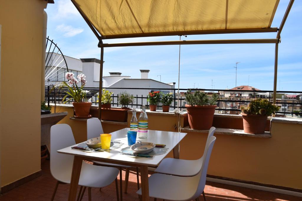 a table and chairs on a balcony with a view at LightHouse - Surfandwindsurferhouse in Anzio