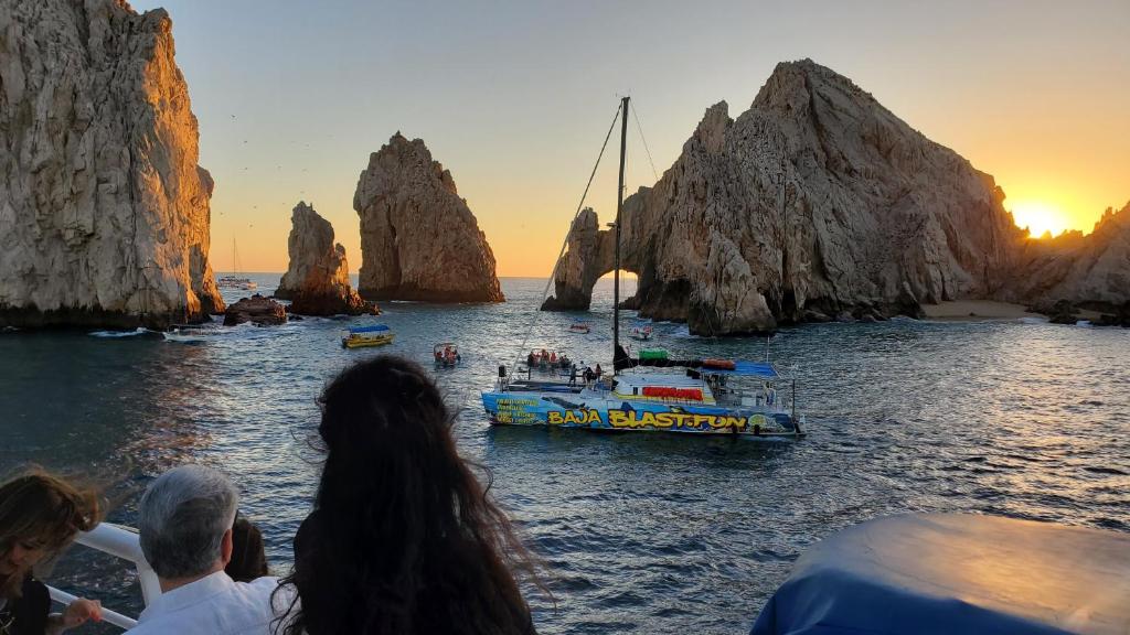 a group of people looking at a boat in the water at Marina Sol in Cabo San Lucas