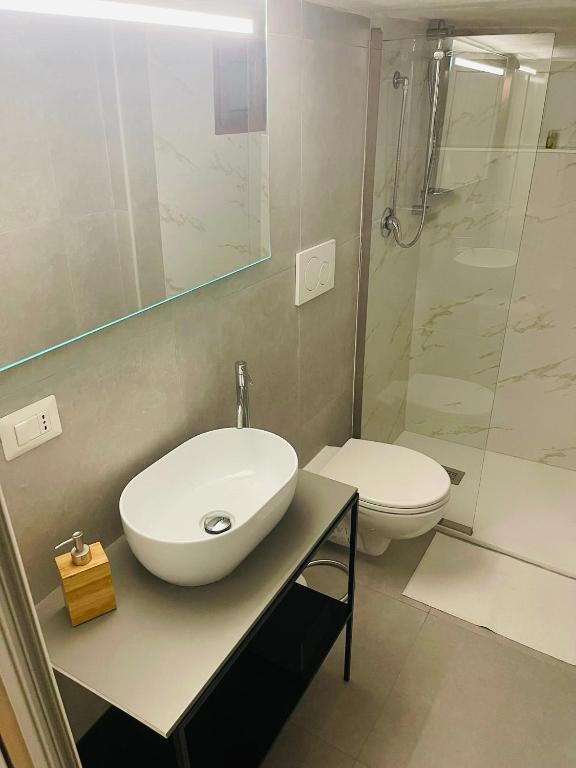 a bathroom with a sink and a toilet and a shower at Corte San Gaetano in Bari