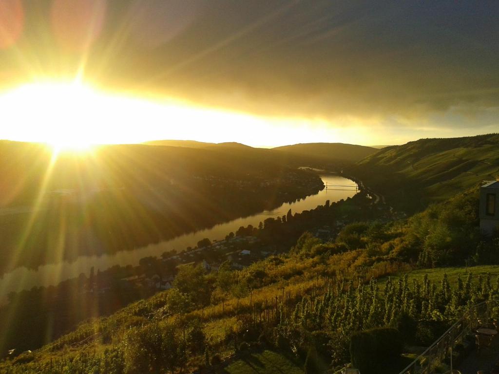 a view of the sun setting over a river at Apartment an der Mosel 2 in Graach